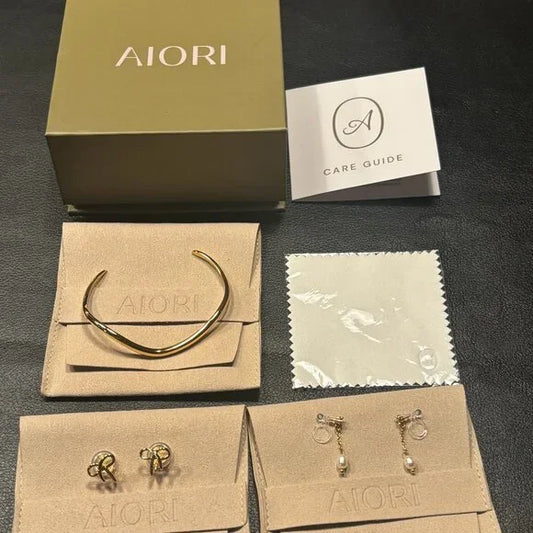 3 PIECES OF AIORI JEWELRY: 2 CLIP ON EARRINGS - 1 BANGLE